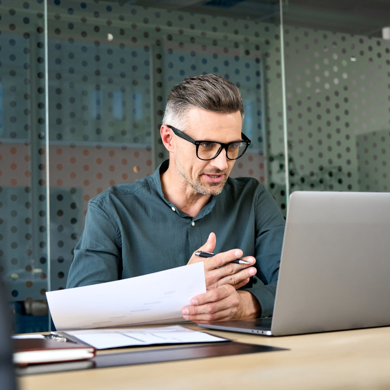 A man on a laptop in a meeting room