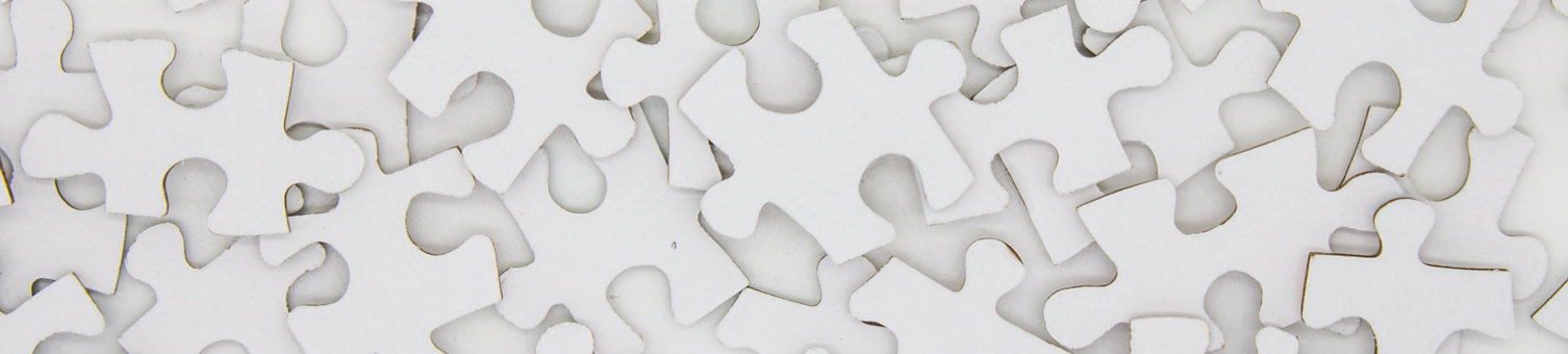 A pile of puzzle pieces on a flat surface