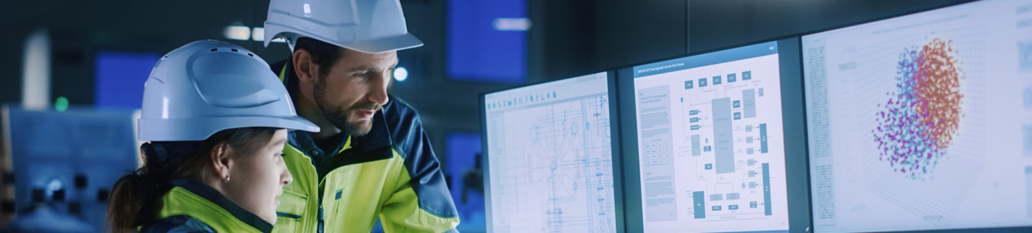 Construction workers looking at computer