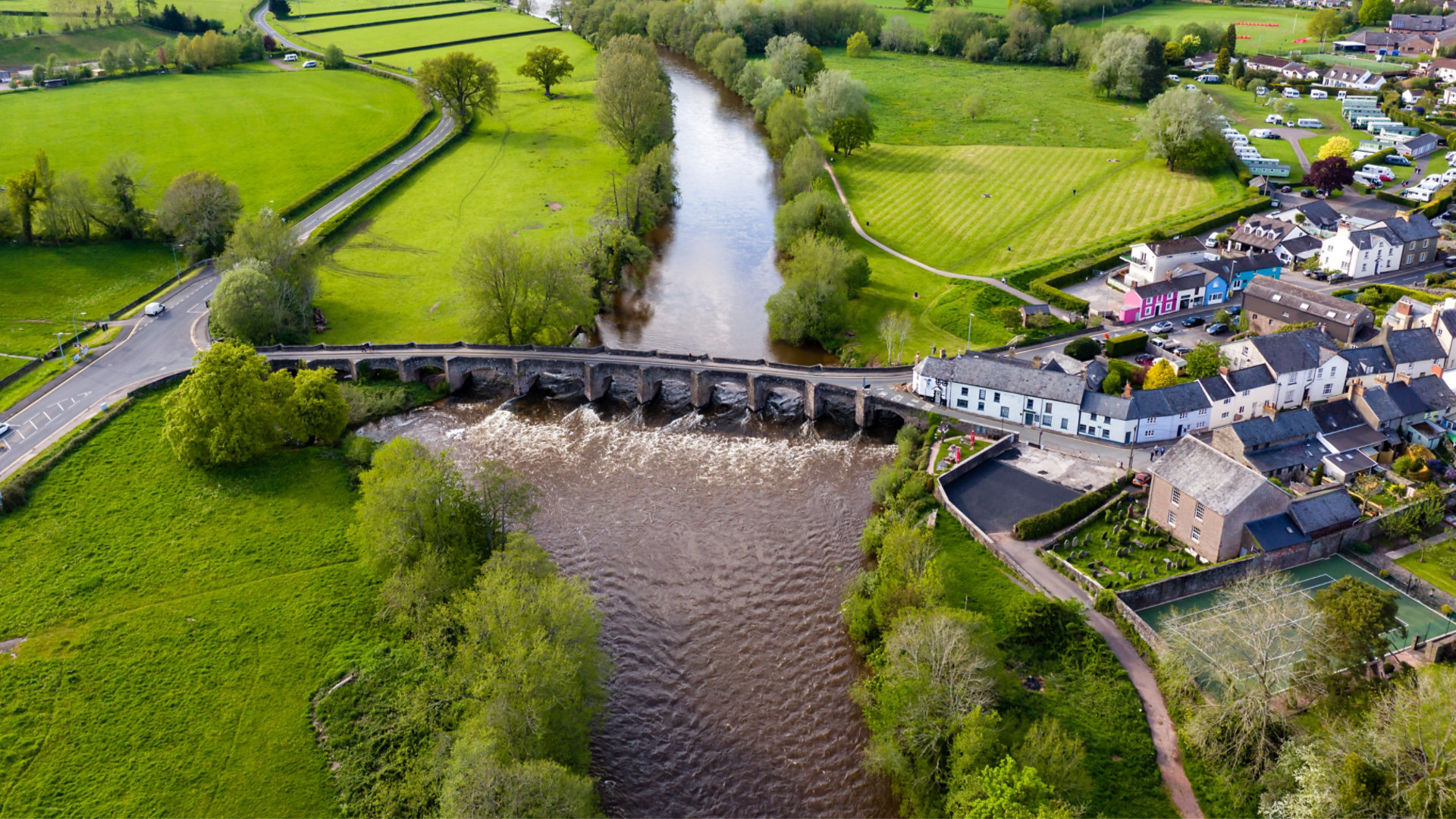 Aerial view of an old bridge across the fast flowing River Usk in Crickhowell, Wales