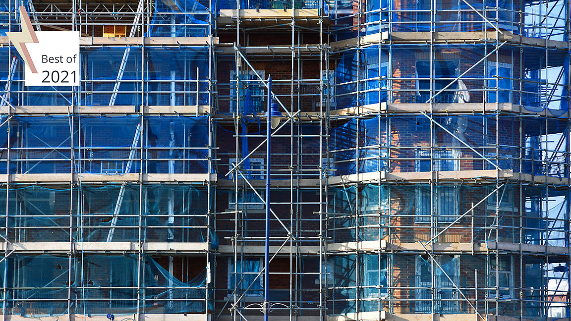 Scaffolding and blue nets on the façade of a building being repaired
