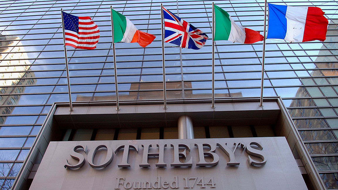 Front entrance of Sotheby's auction house New York, flying international flags