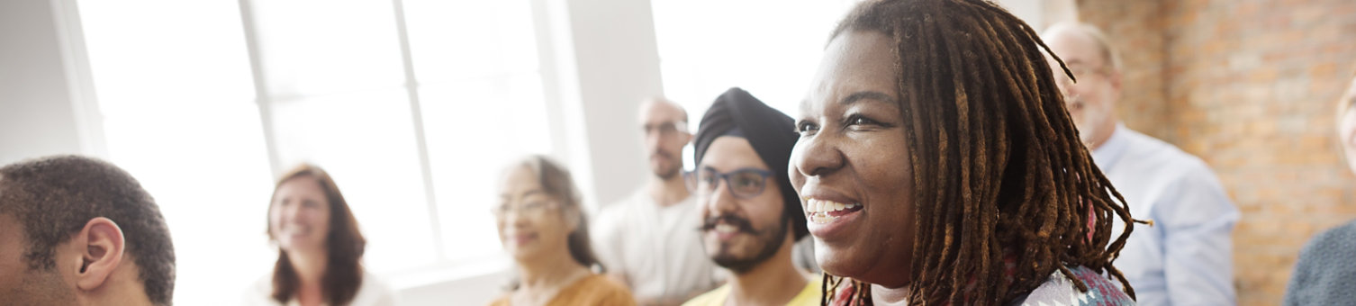A diverse group of people watching a presentation seminar 