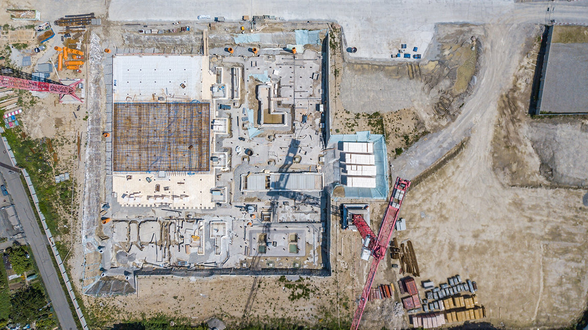Aerial view of construction site on sunny summer day.