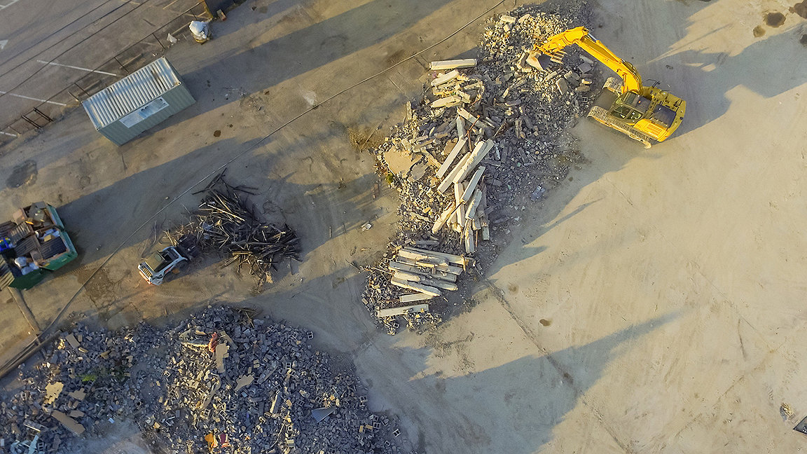 overhead shot of construction recycling material being sorted by machine on-site