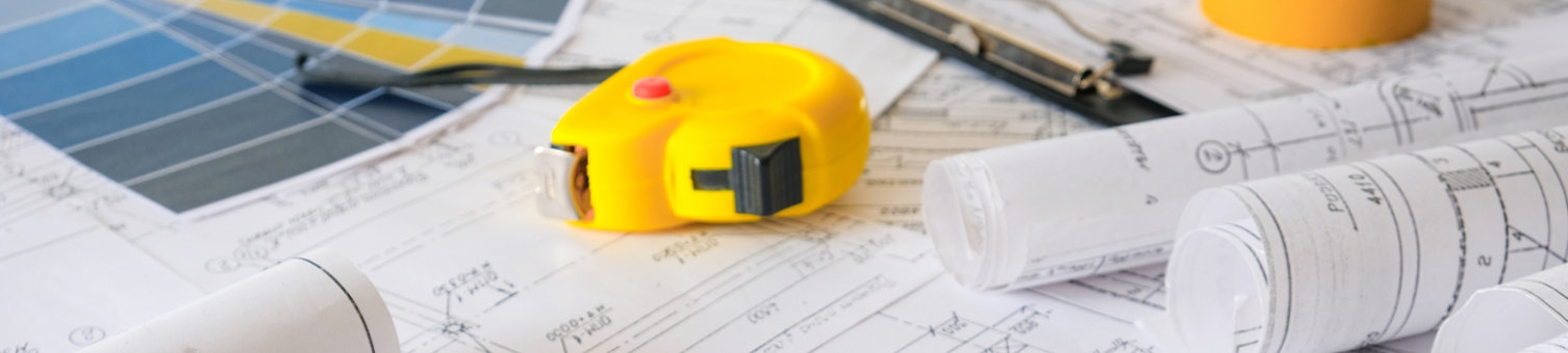 Blueprints on table with tape measure