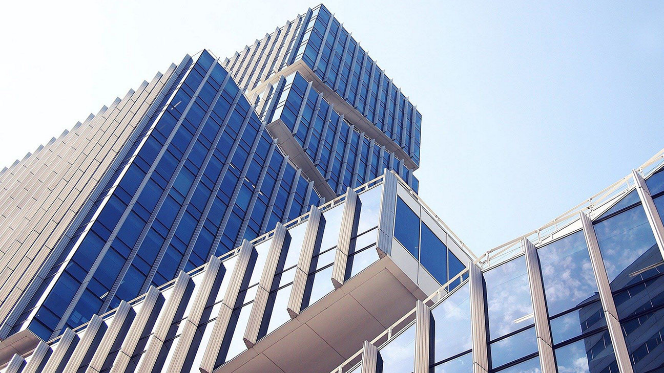 A photograph of a high-rise building as taken from below