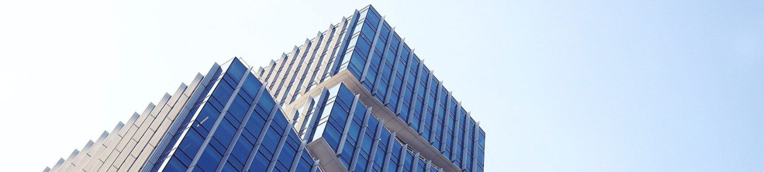 A photograph of a high-rise building as taken from below