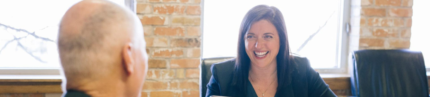 Woman laughing during business meeting