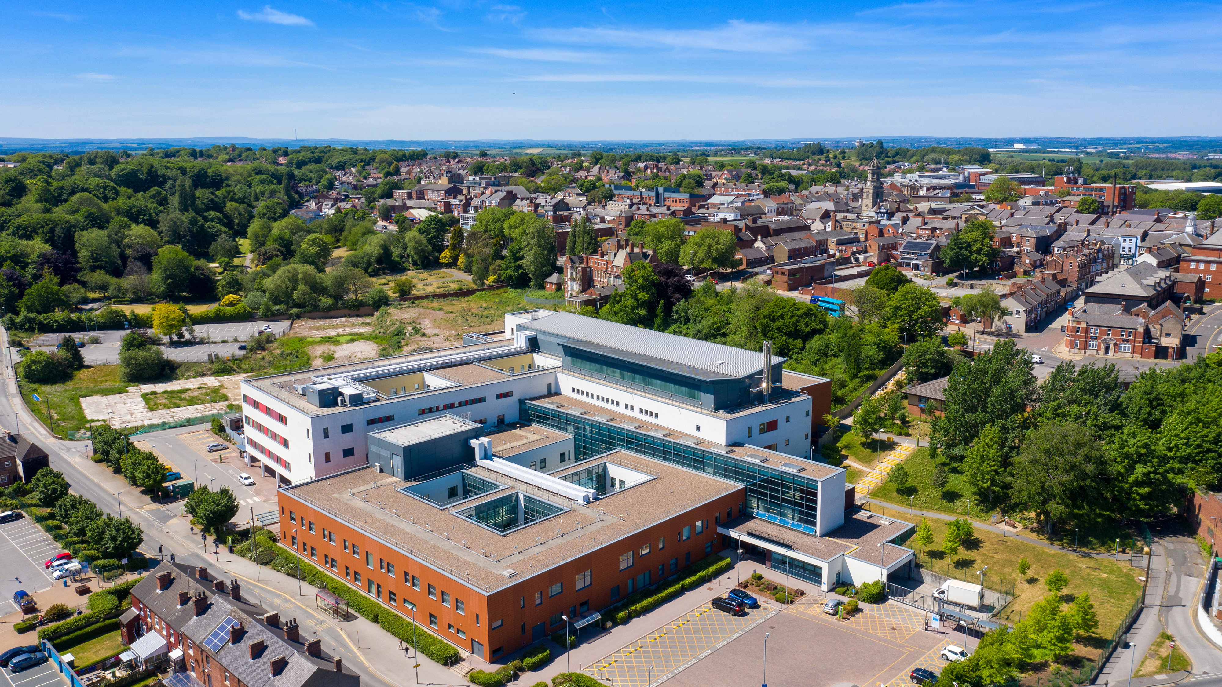 Medium-sized UK hospital view from above with town in background