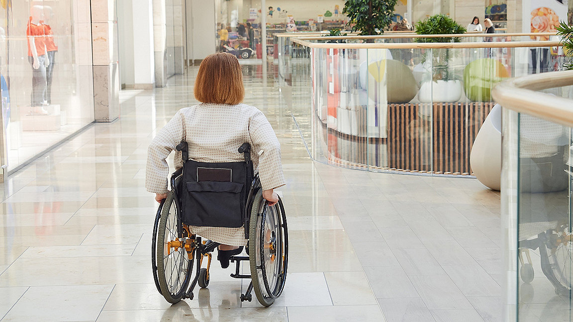 Photo of woman in wheelchair in a shopping centre