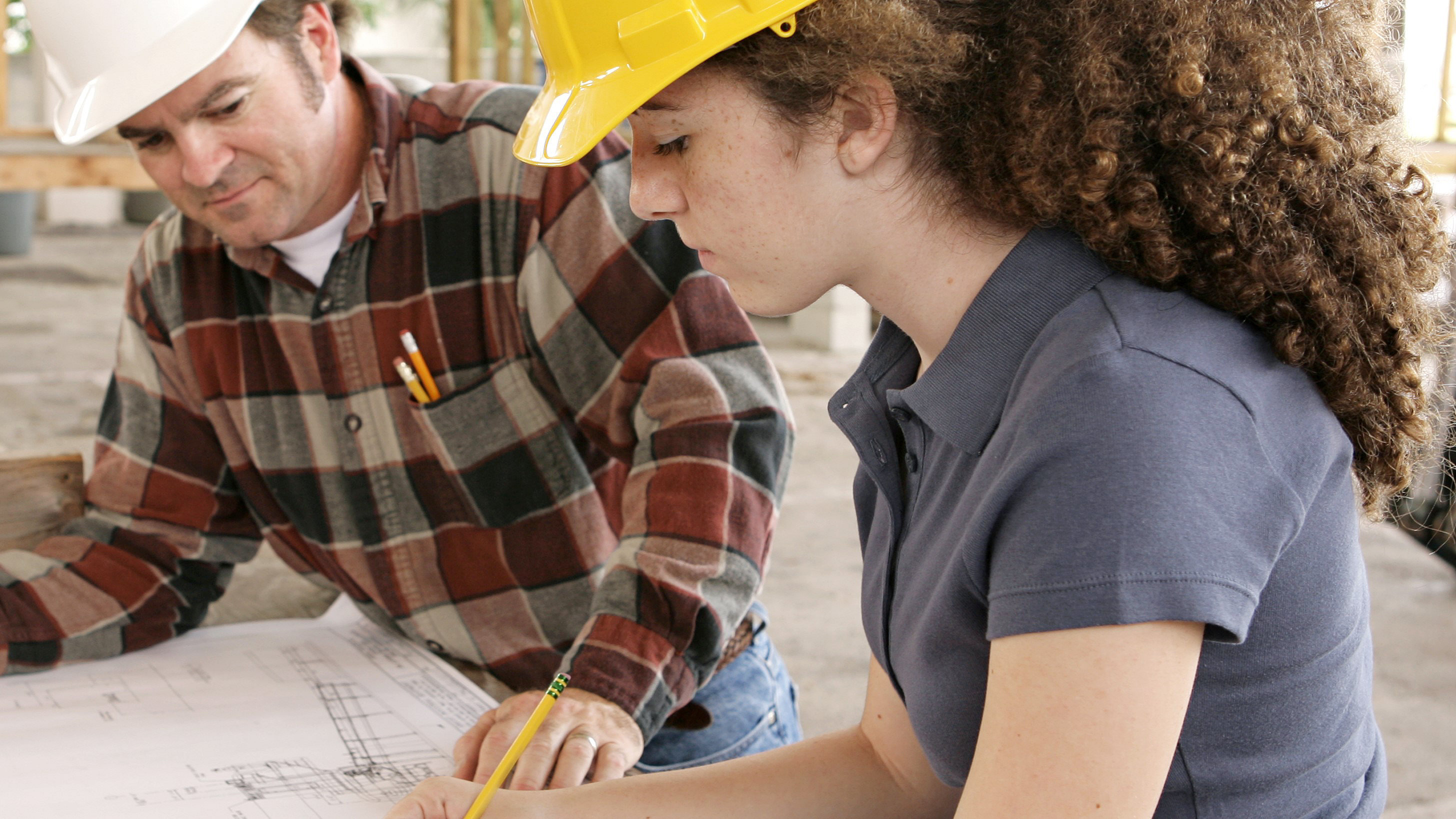 Young woman on site with drawings