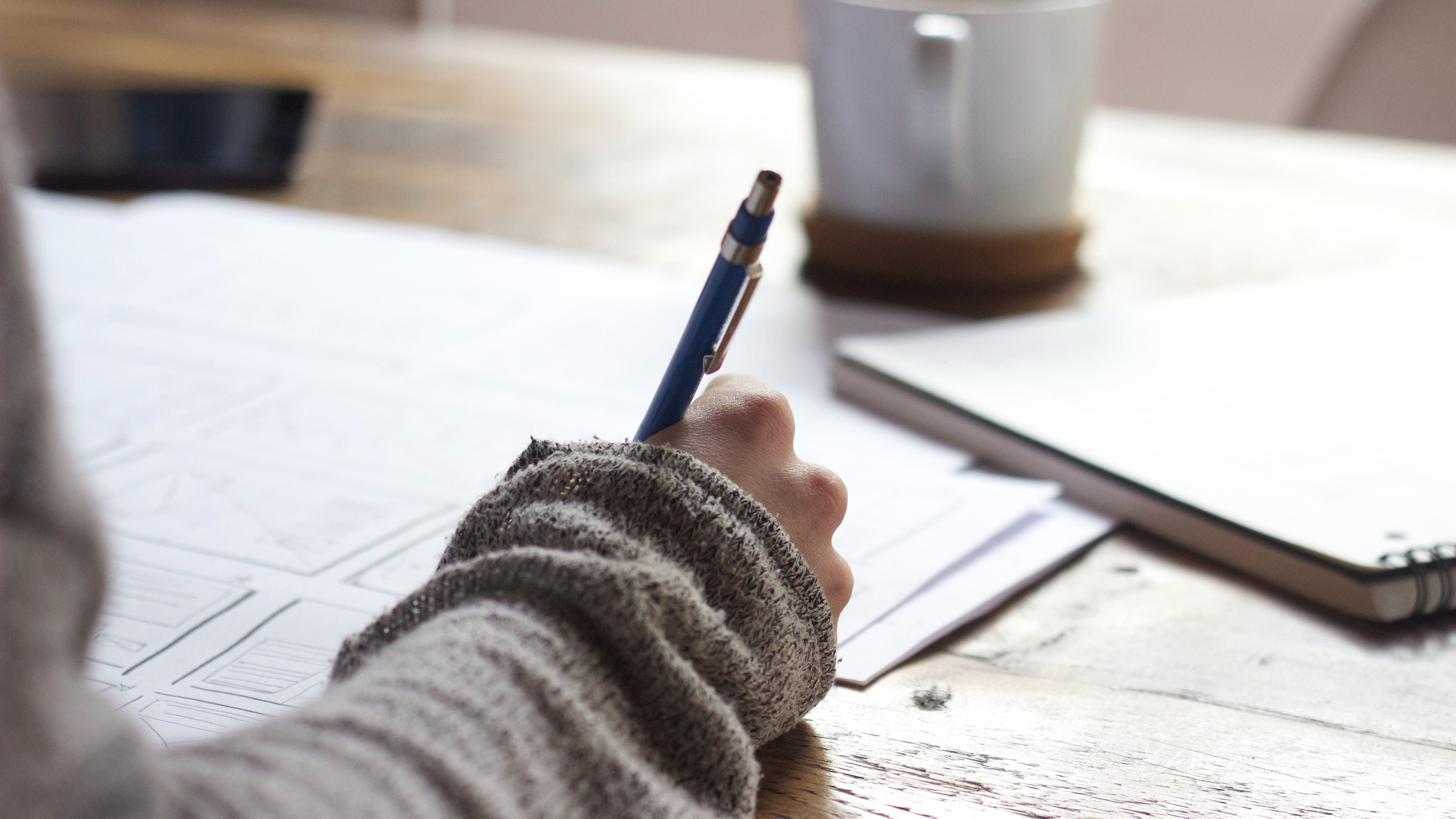 young woman writing at desk