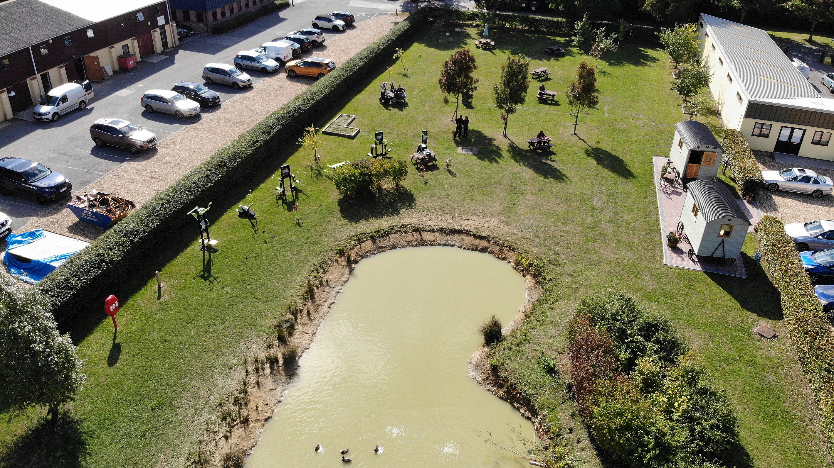 Aerial view of business park with lake and outdoor exercise equipment