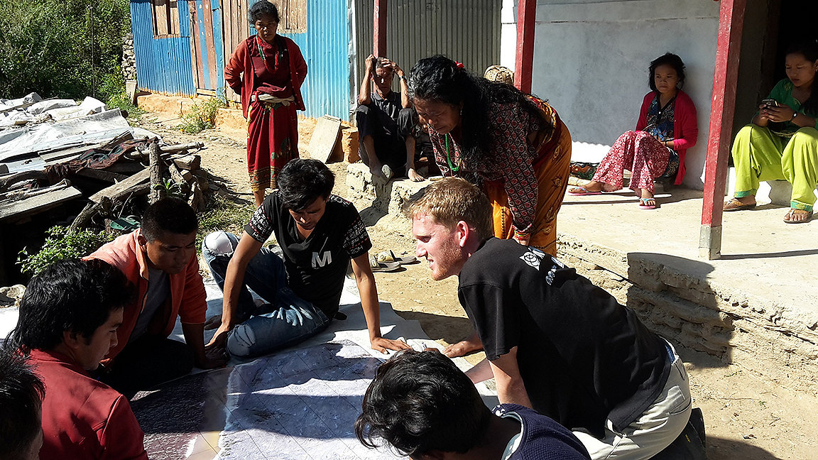 Jordan Friis, a VCS in Nepal, 2017, working with locals on a map