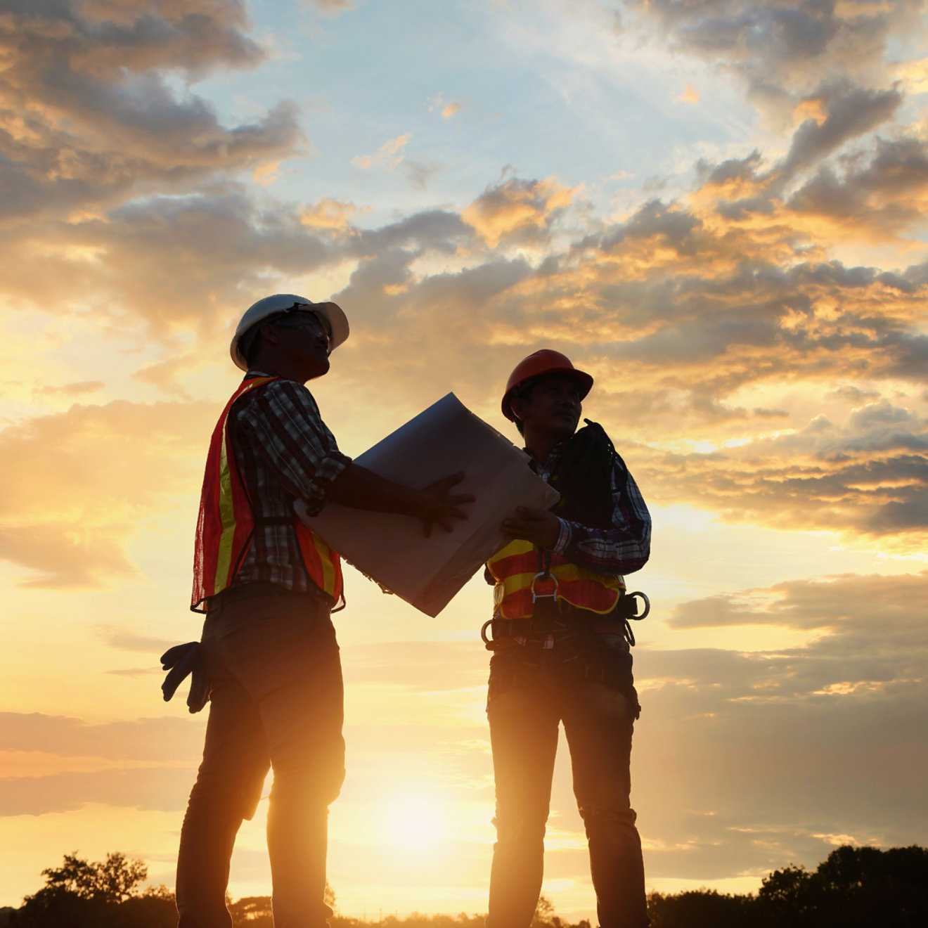 Construction workers with sunset