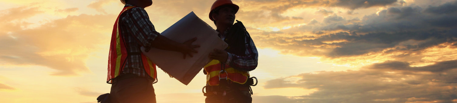 Construction workers with sunset