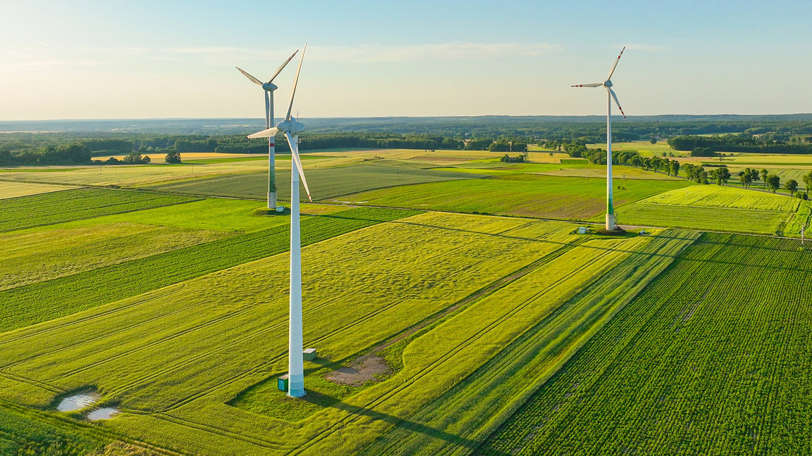 Wind power turbines on green field in countryside