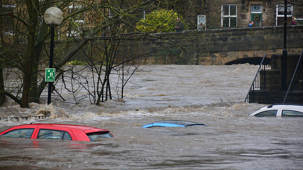 Flooded road showing submerged cars