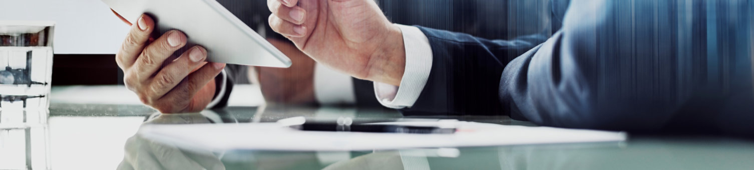 Corporate businessmen working on tablet at office