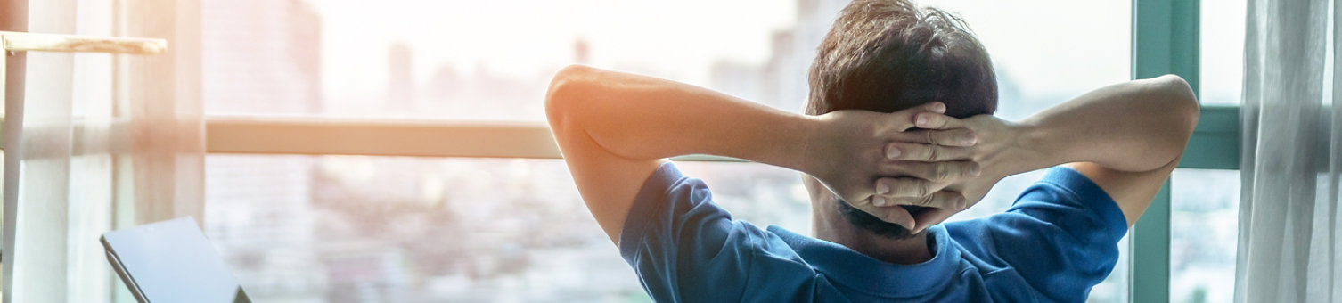 Life-work balance and city living lifestyle concept of business man relaxing, take it easy in office or hotel room resting with thoughtful mind thinking of life quality looking forward to cityscape 