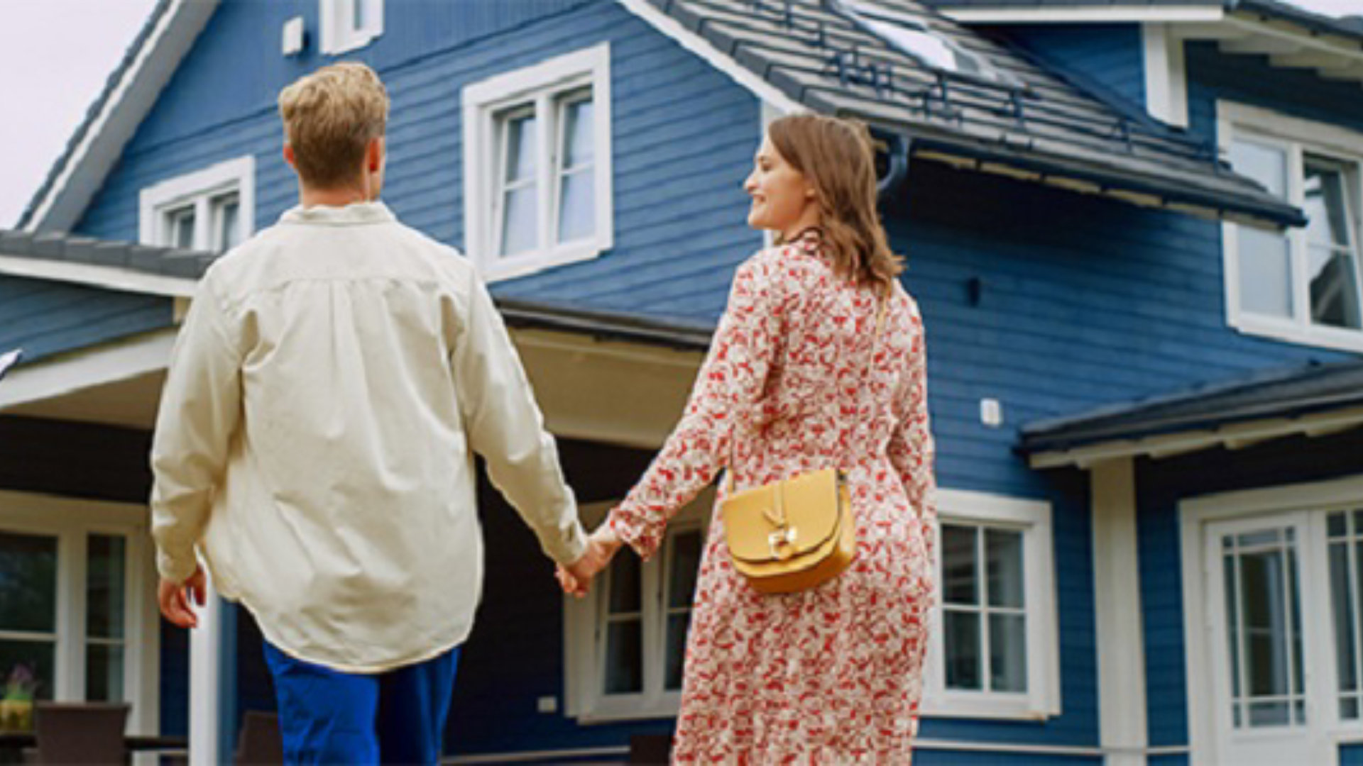 couple standing infront of house