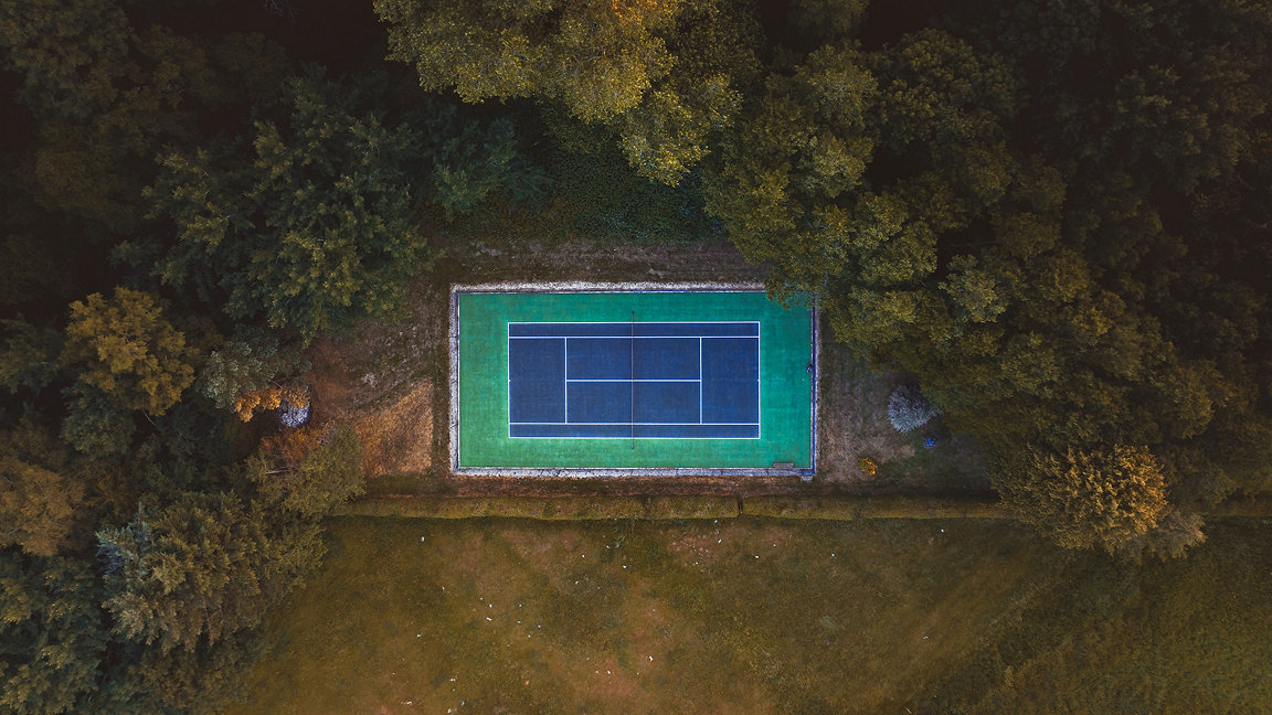 Tennis court from above hidden in trees