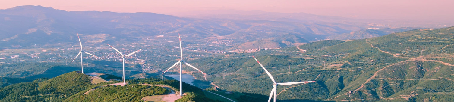 Wind turbines spinning in the wind energy station in mountain. Aerial view