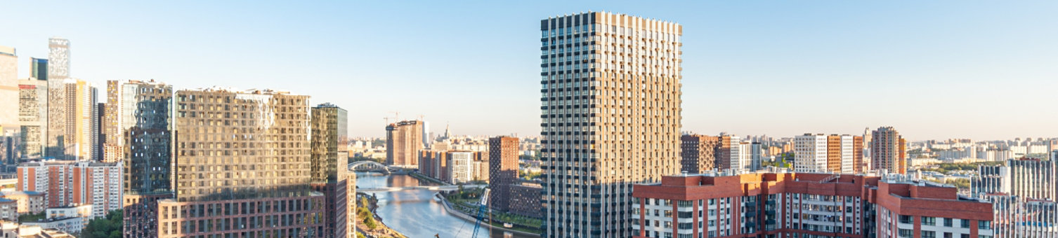 A new residential area in the capital Moscow Khoroshevo Mnevniki and Filevsky Park with high-rise buildings and a bridge under construction across the Moskva River with a overhead view of Moscow City