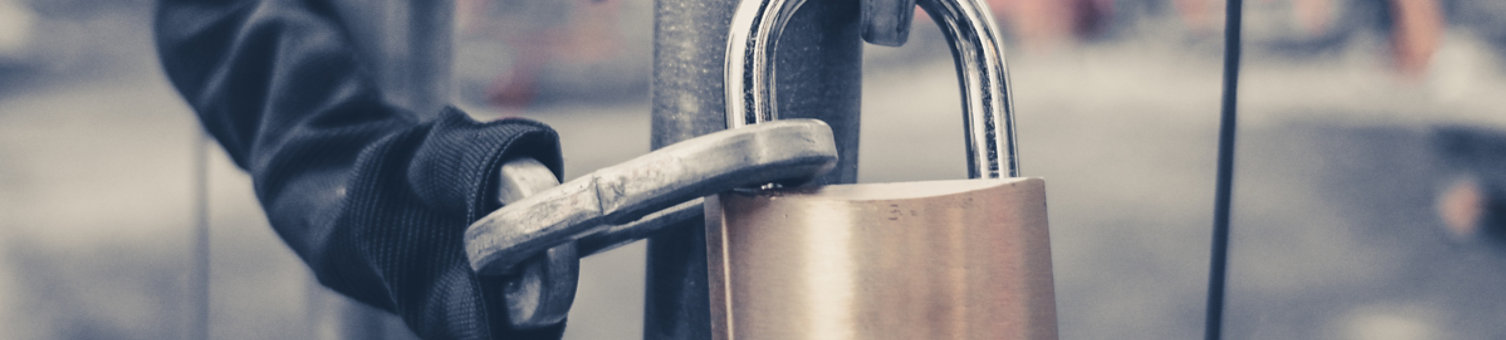 chain and padlock on gate at construction site - lock on closed fence
