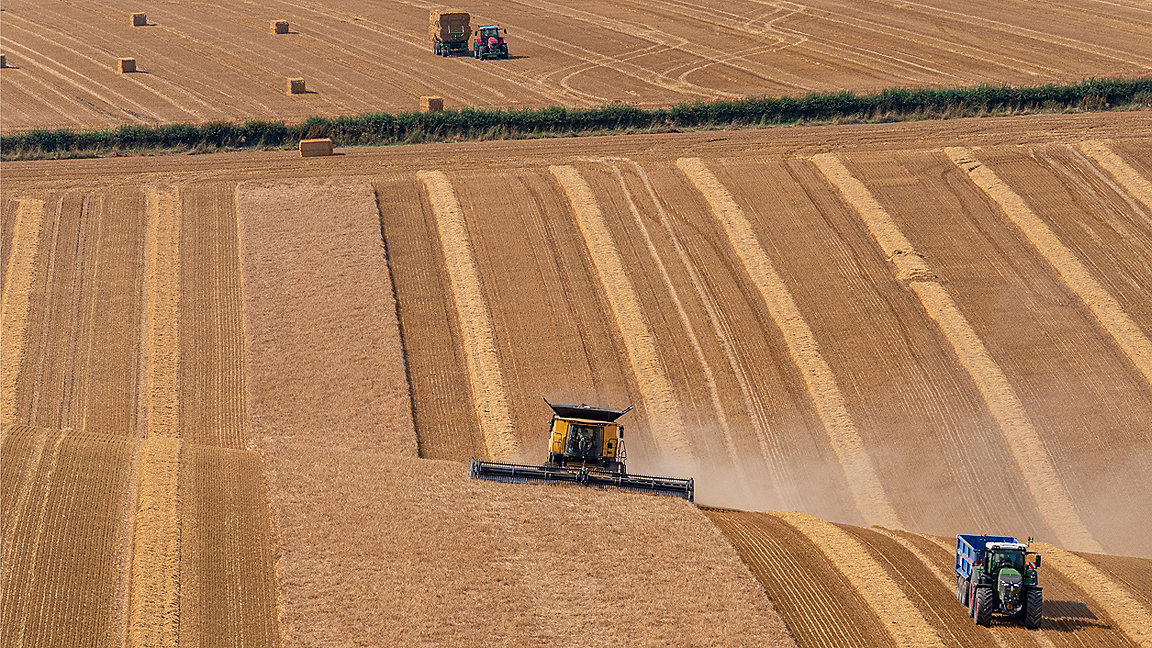 Agricultural machinery in fields harvesting