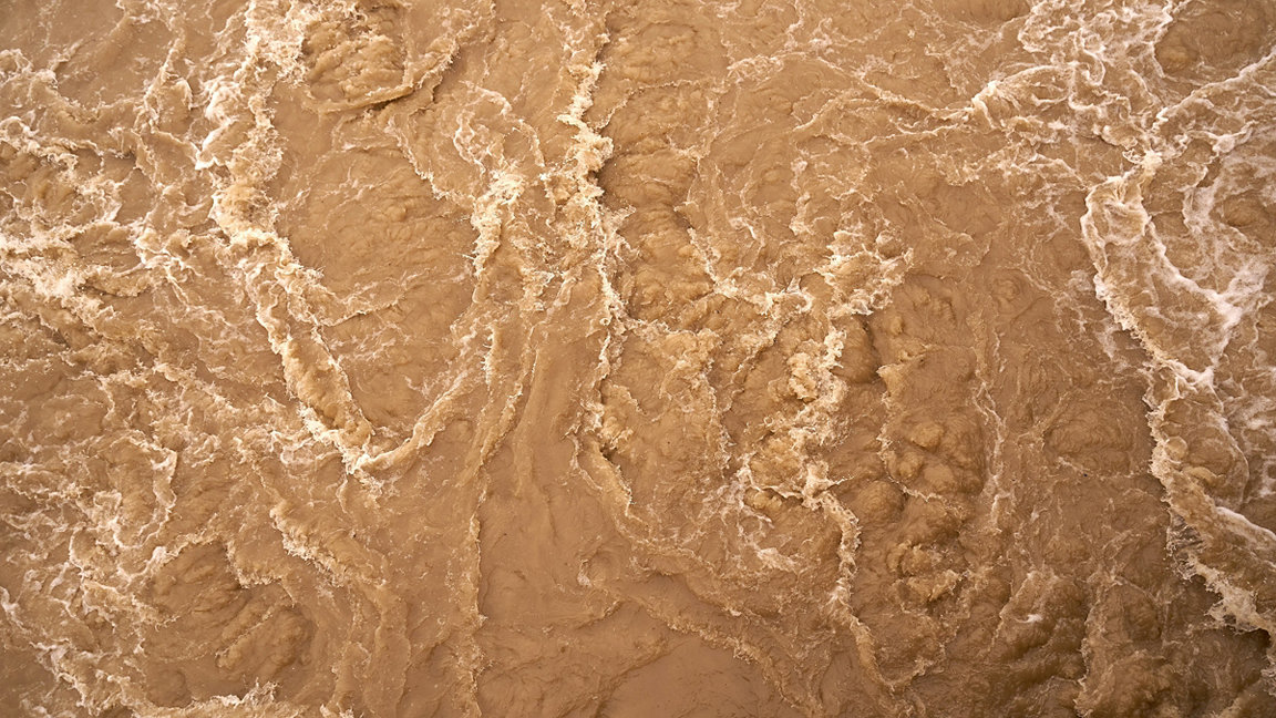 Churning brown water, abstract