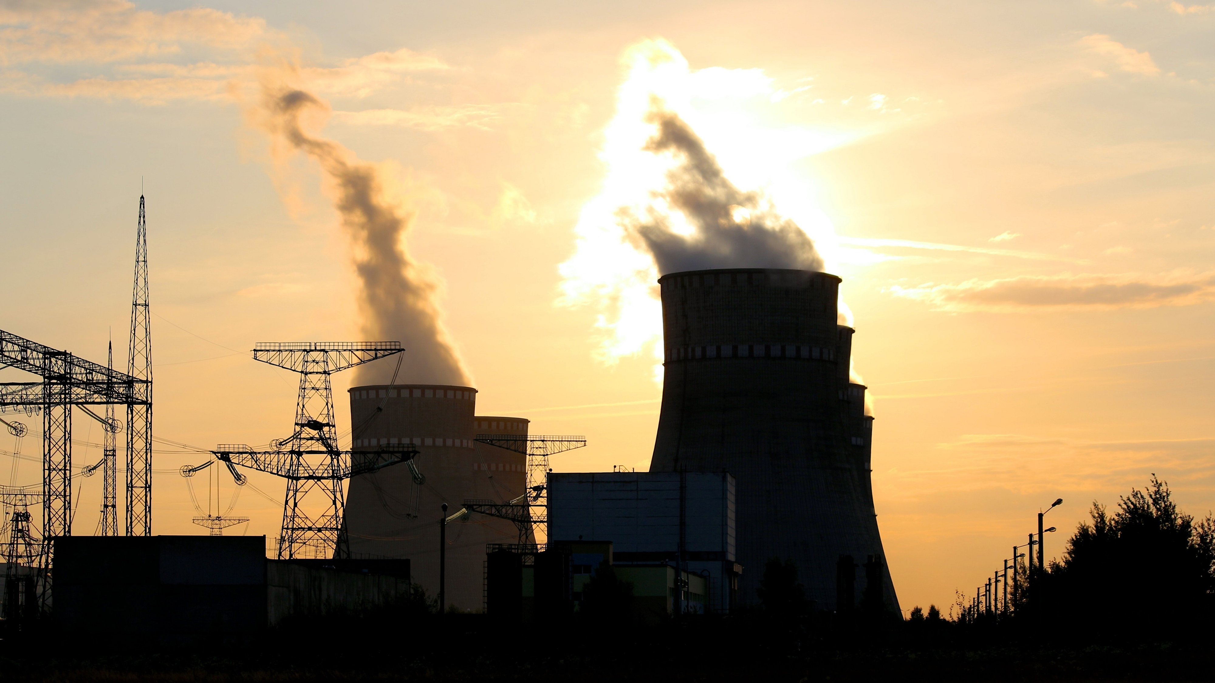 Steam towers against sunset