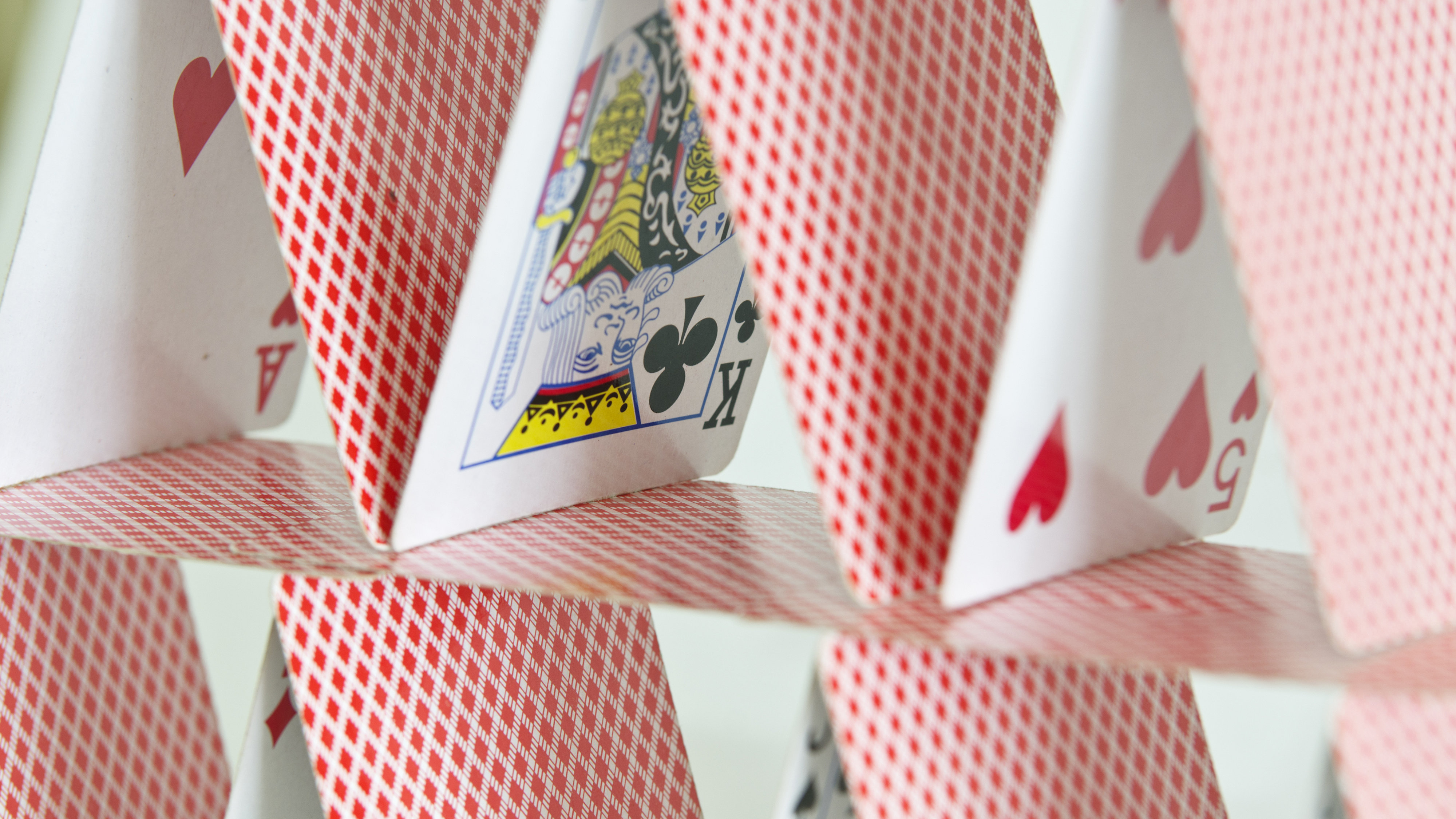 Playing cards stacked on top of one another to form a house