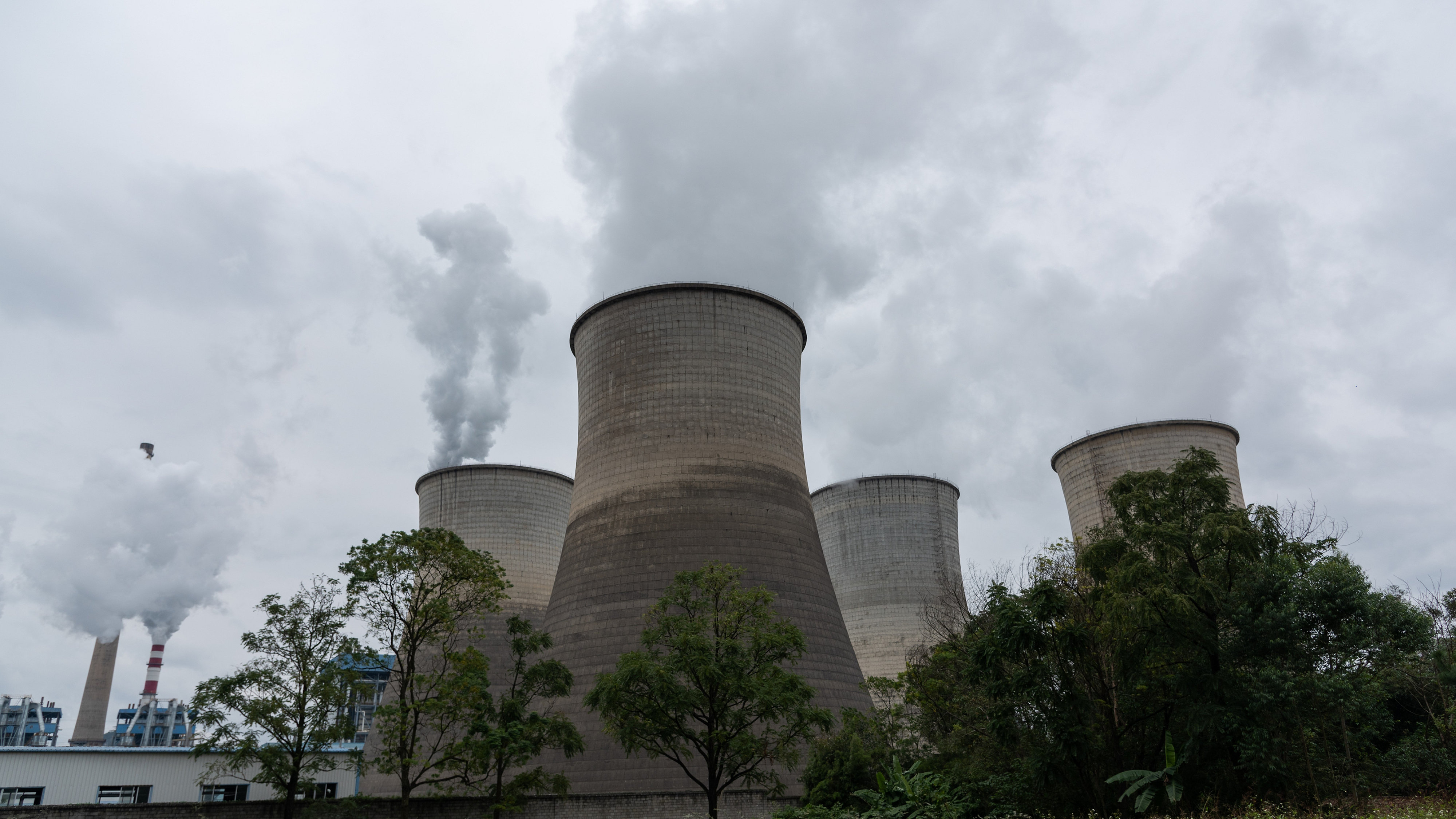 Tall chimneys emitting smoke