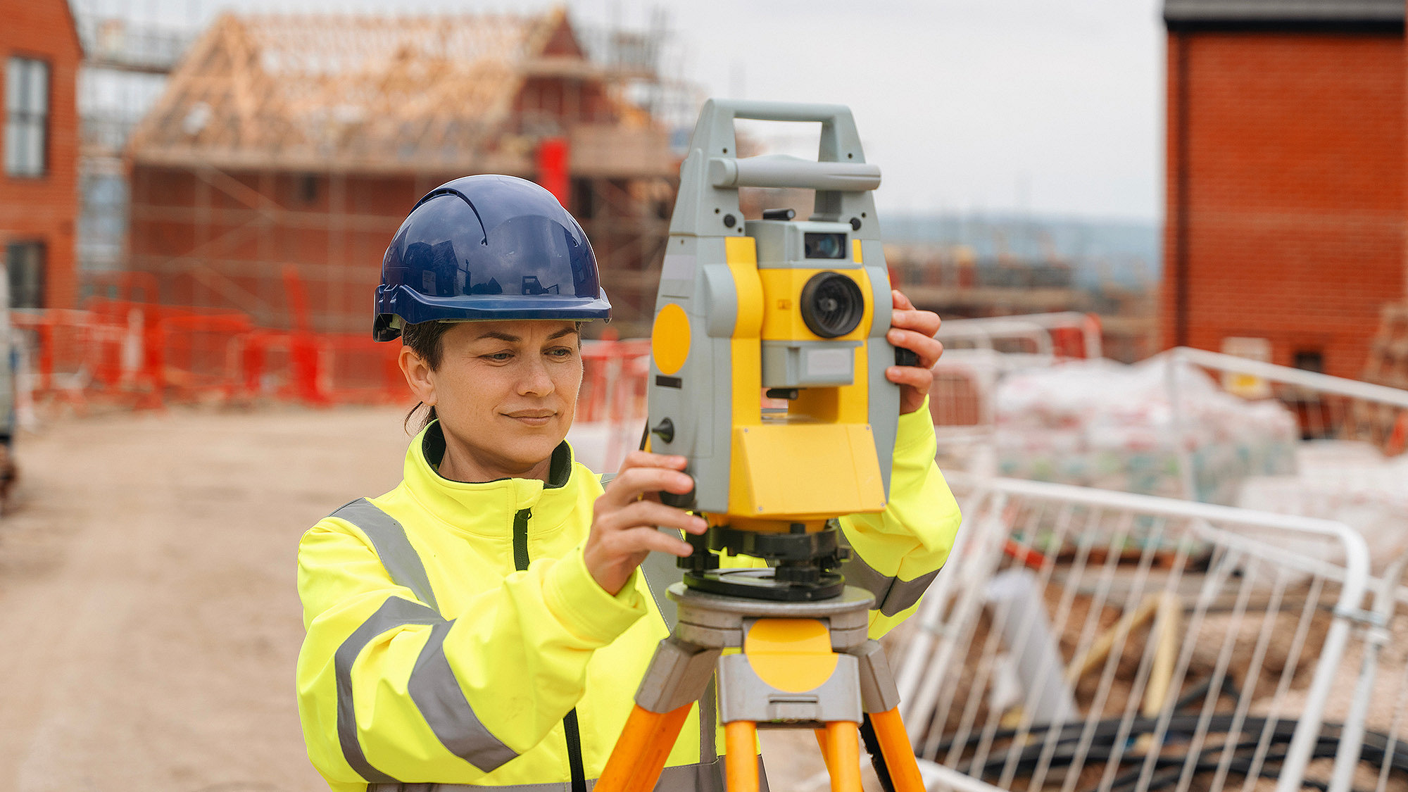 Colour photograph of a female surveyor using an alidade