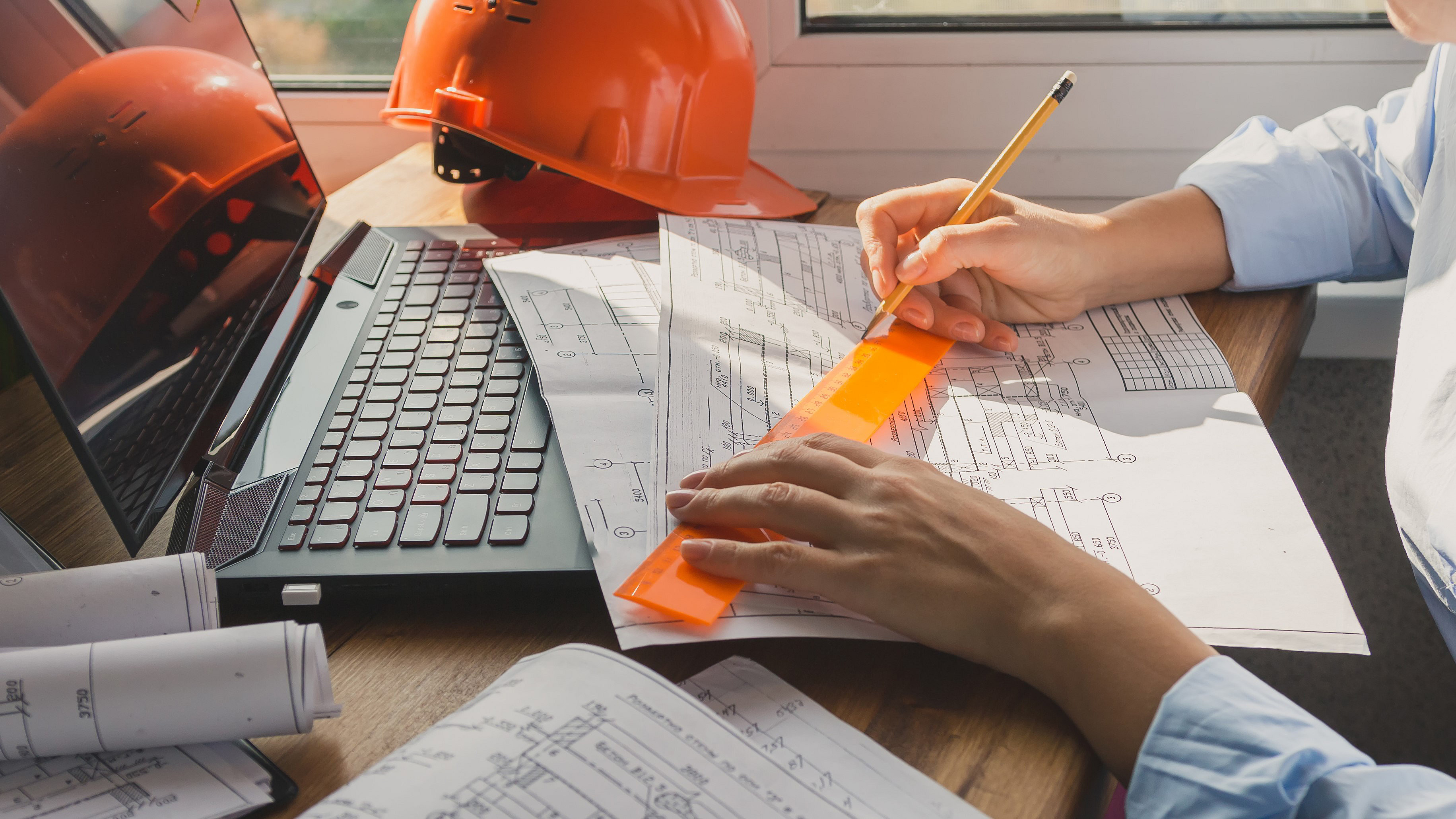 Woman seated at office desk with drawings