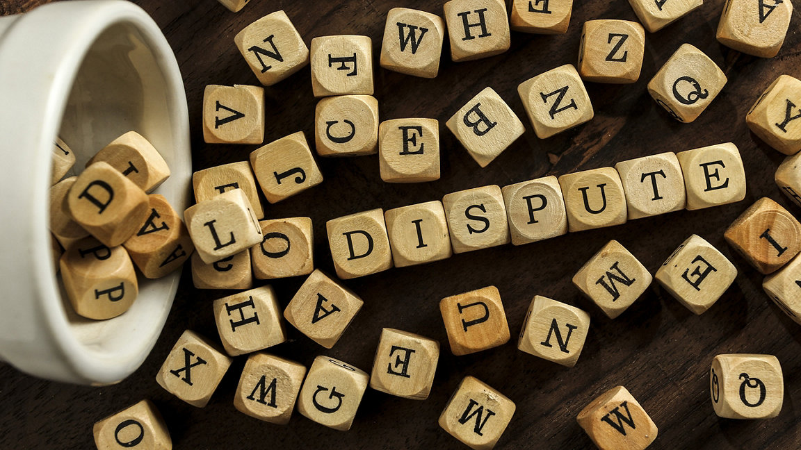 The word DISPUTE on wooden blocks 