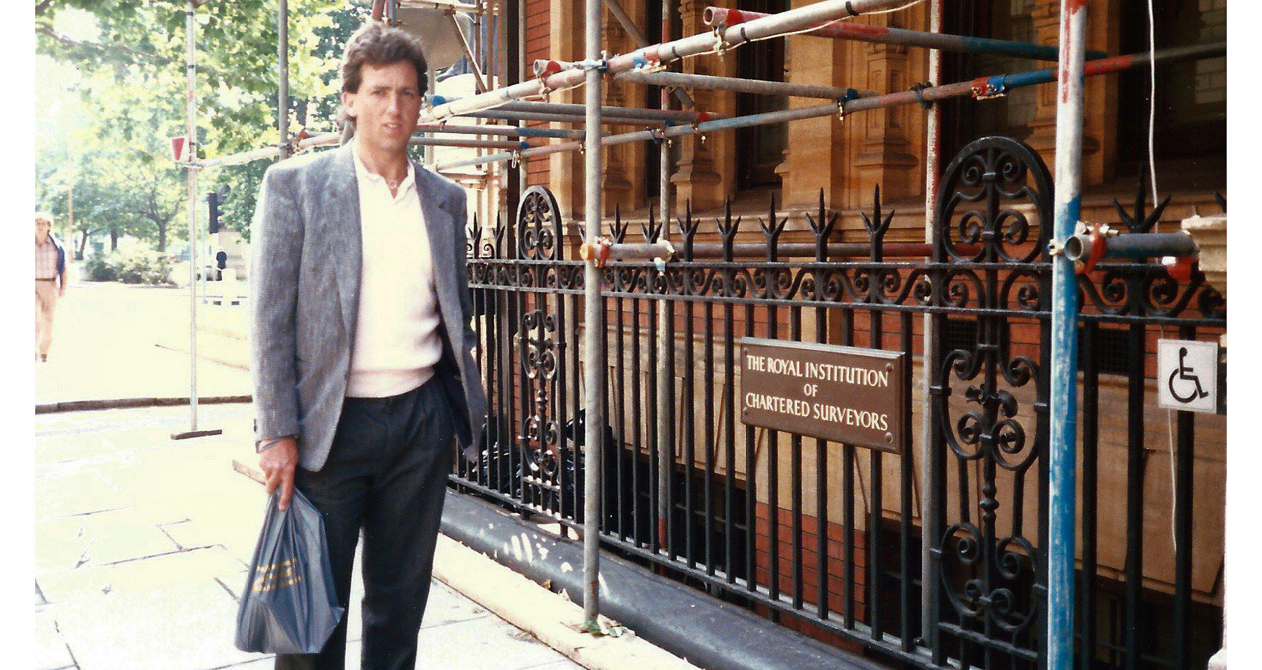 Photo of Don Lemen in front of the RICS headquarters in London