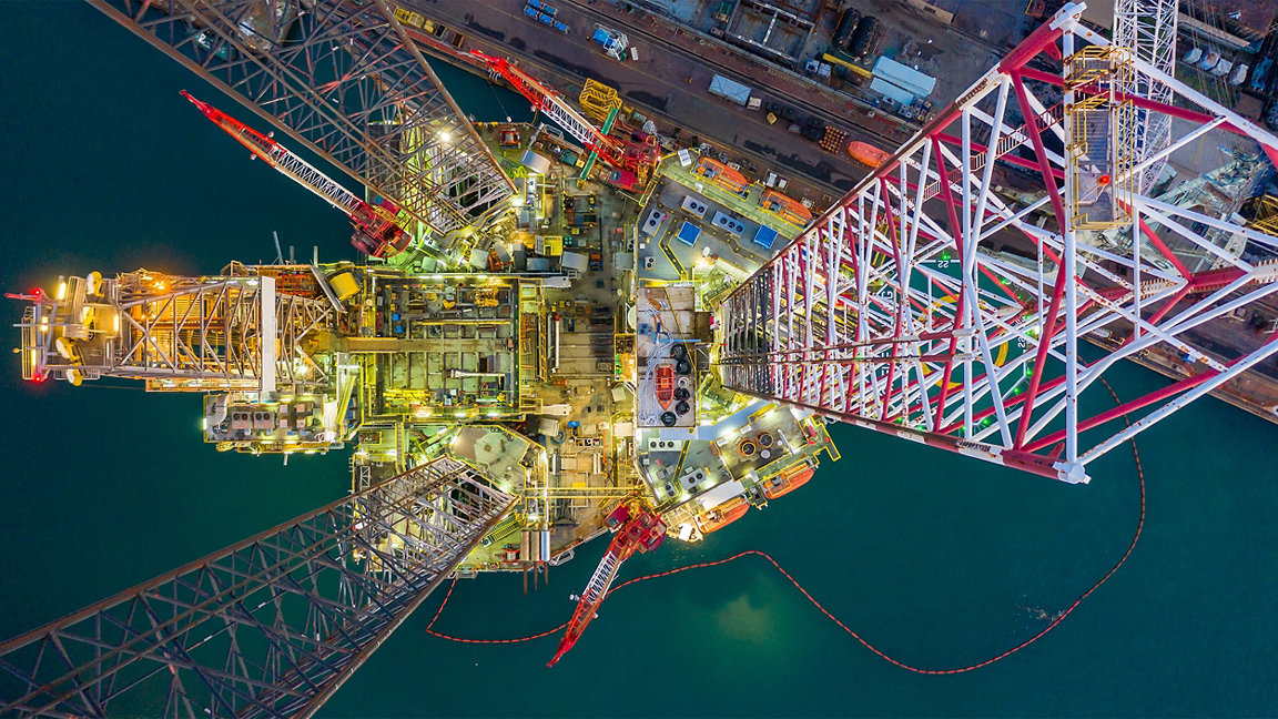 Aerial view jack up rig under maintenance at night