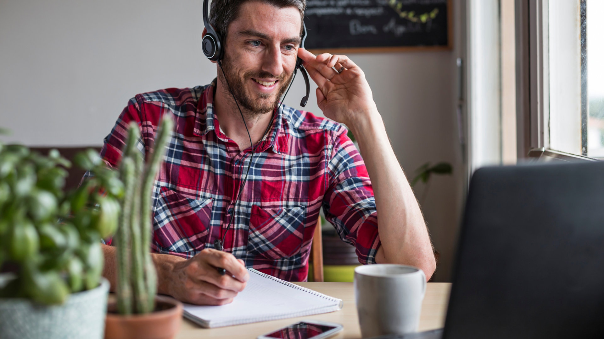 Man sat at desk, working from home in conference call with colleagues using headset; Shutterstock ID 2017358114; purchase_order: N/A; job: K&C Development & Qualification Packages Campaign ; client: RICS_PP; other: 