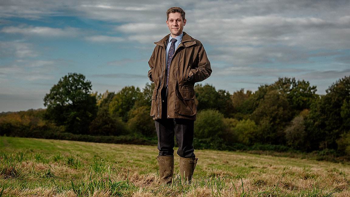 Jonathan Morris, rural surveyor, standing in a field