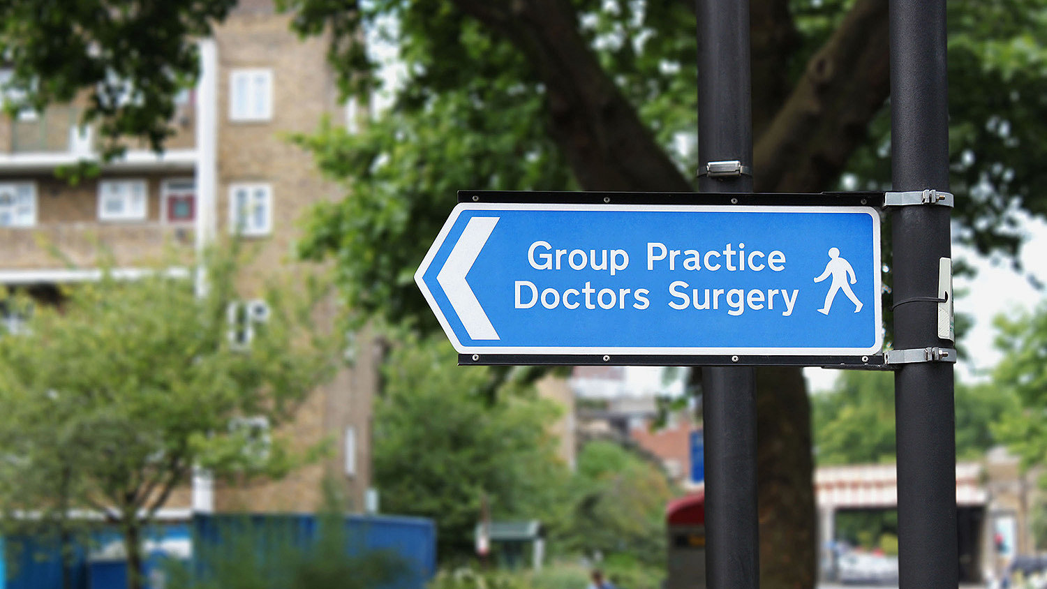 Photo of a street sign with the words 'Group Practice Doctors Surgery'