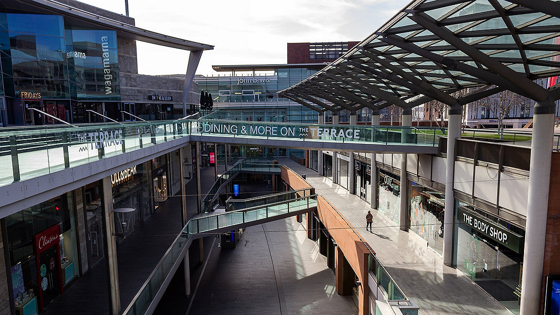 Empty multi-level Liverpool shopping mall in March 2020 with single person in shot
