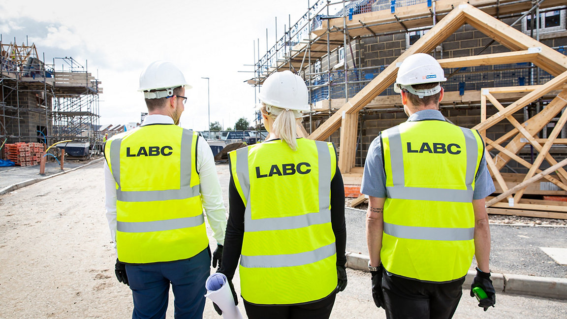Three LABC surveyors walking on construction site