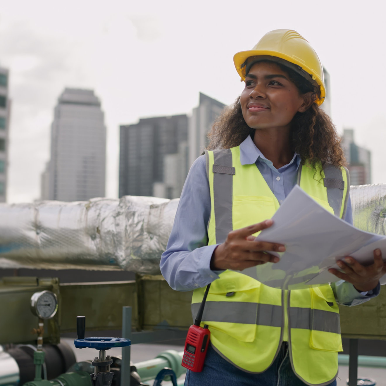 Civil engineer woman dark skin wearing uniform and safety helmet under inspection and checking plan on factory plant station by tablet.Civil Engineer,Industry,construction,Industry maintenance concept