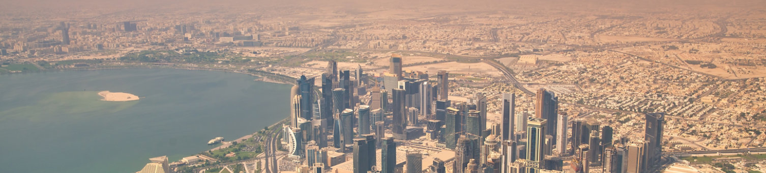 Aerial view of Doha skyline from airplane. Corniche and modern buildings, Qatar.
