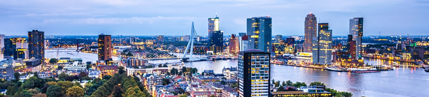 A dynamic image of Rotterdam’s skyline, highlighting the city’s modern architecture and vibrant harbor. The photo captures the essence of Rotterdam’s architectural innovation and maritime activity.