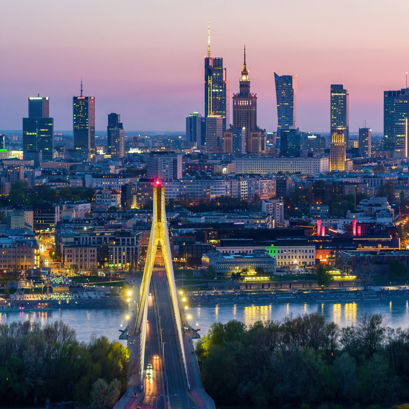 Evening aerial panorama of Warsaw city center, Vistula river and Swietokrzyski bridge