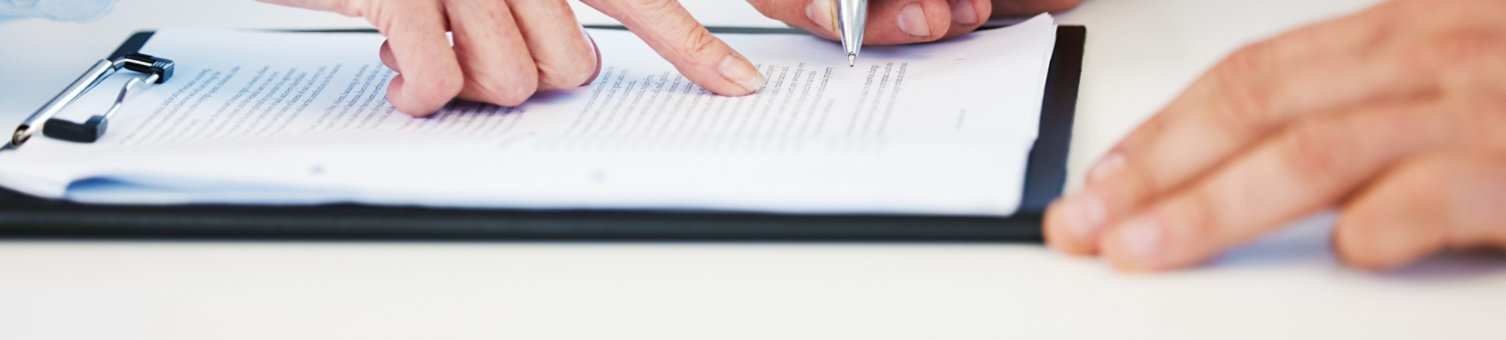 Hands making notes in an office setting
